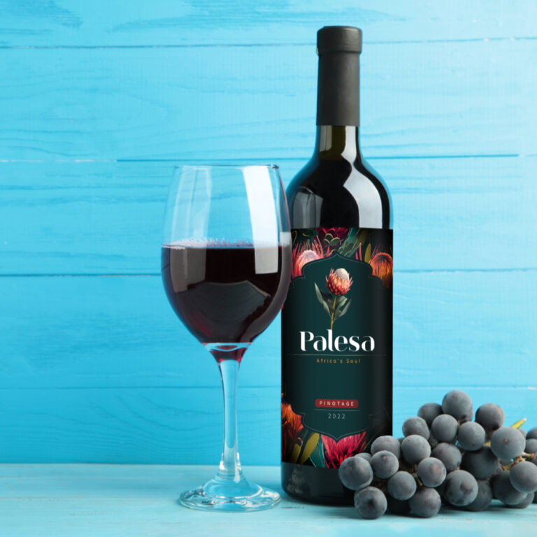 Wine bottle and wine glass with grapes on blue wooden background. Space for text. Top view